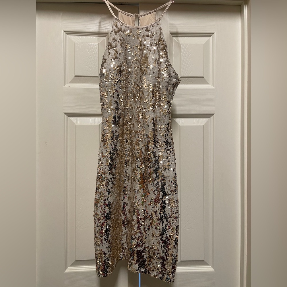 Fitted dress. Sequins are gold on one side and white on the other. Worn once.